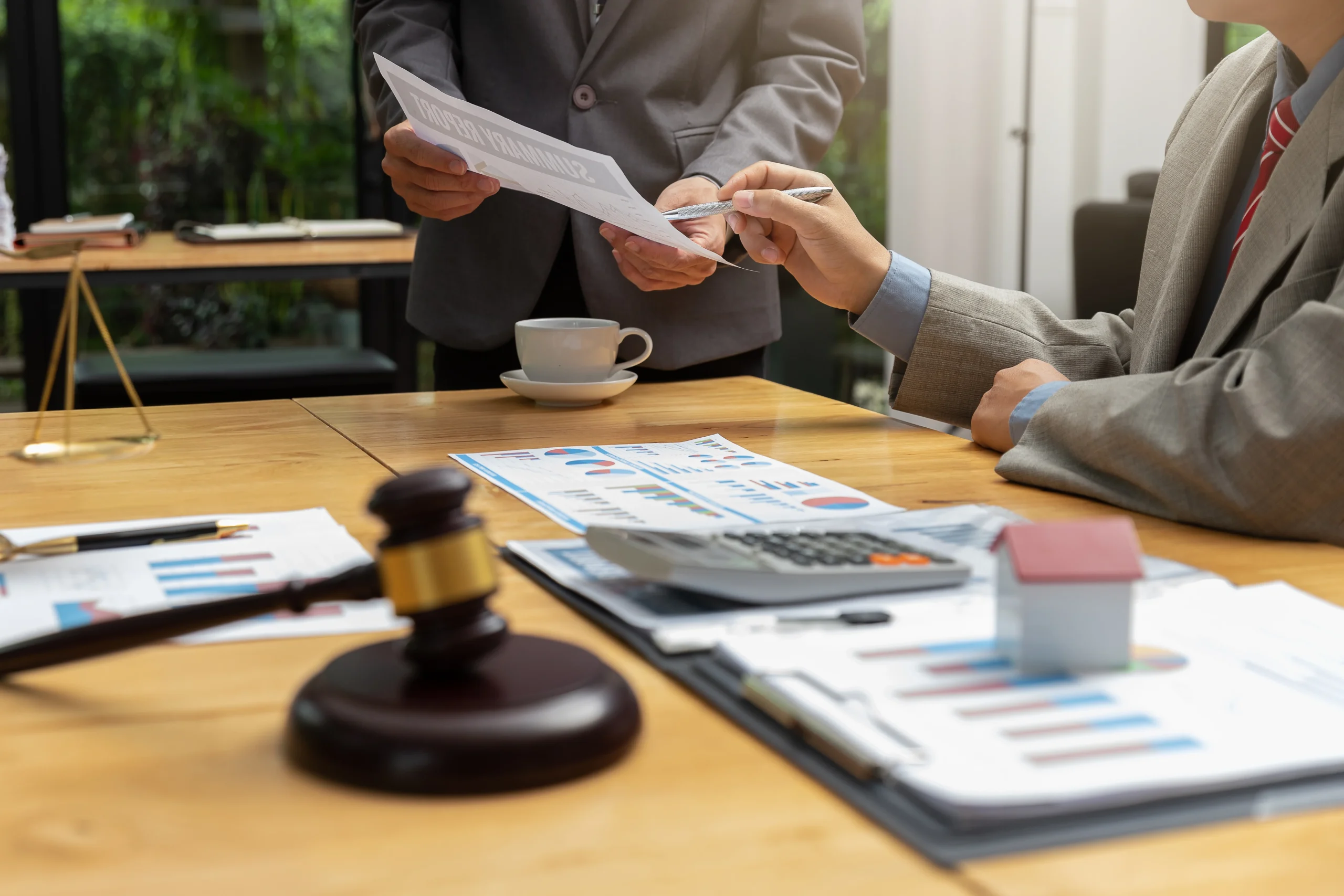 Tax attorney meets to discuss audit reports with business man. Call us for an experienced Austin business tax attorney who understands collection tax law.