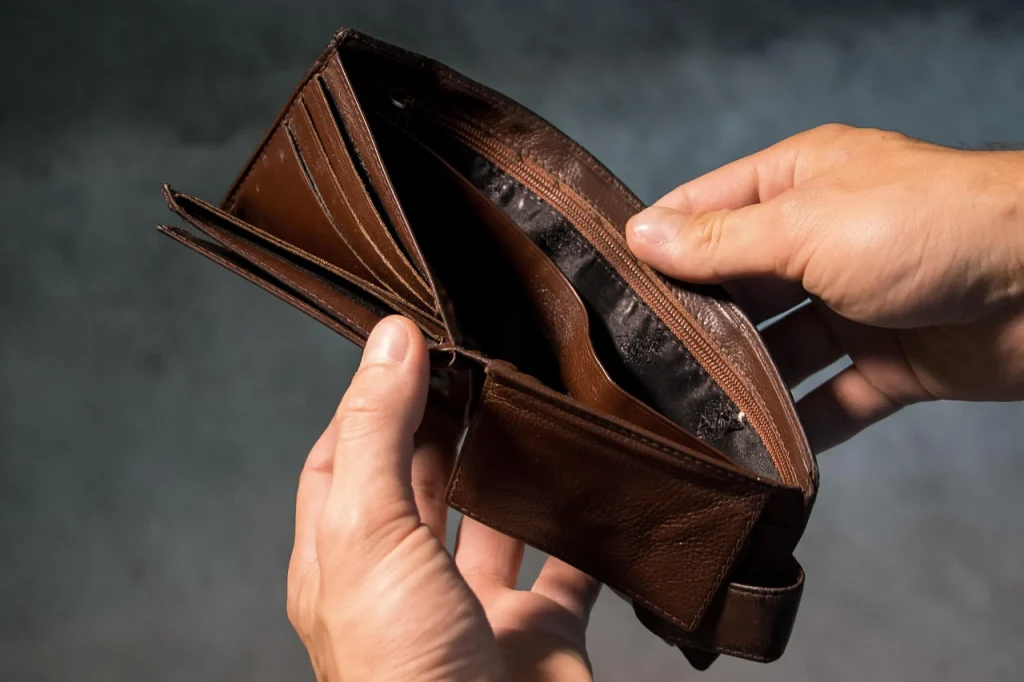 man looking into an Empty wallet.