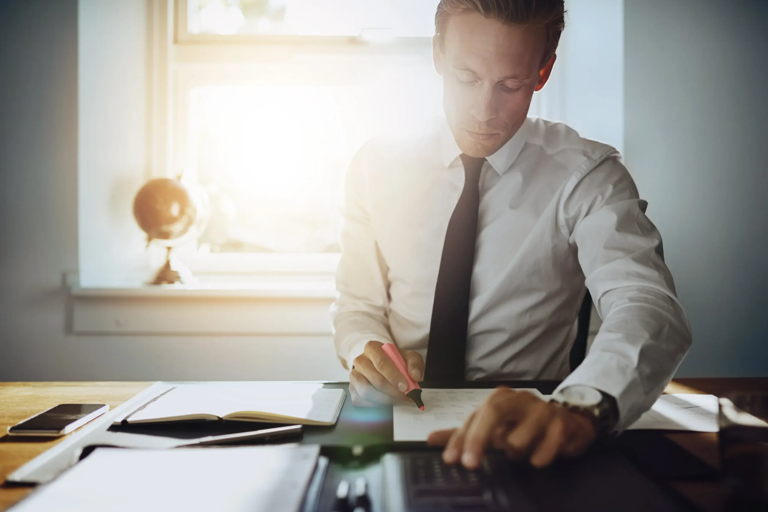 An attorney writing at his desk.