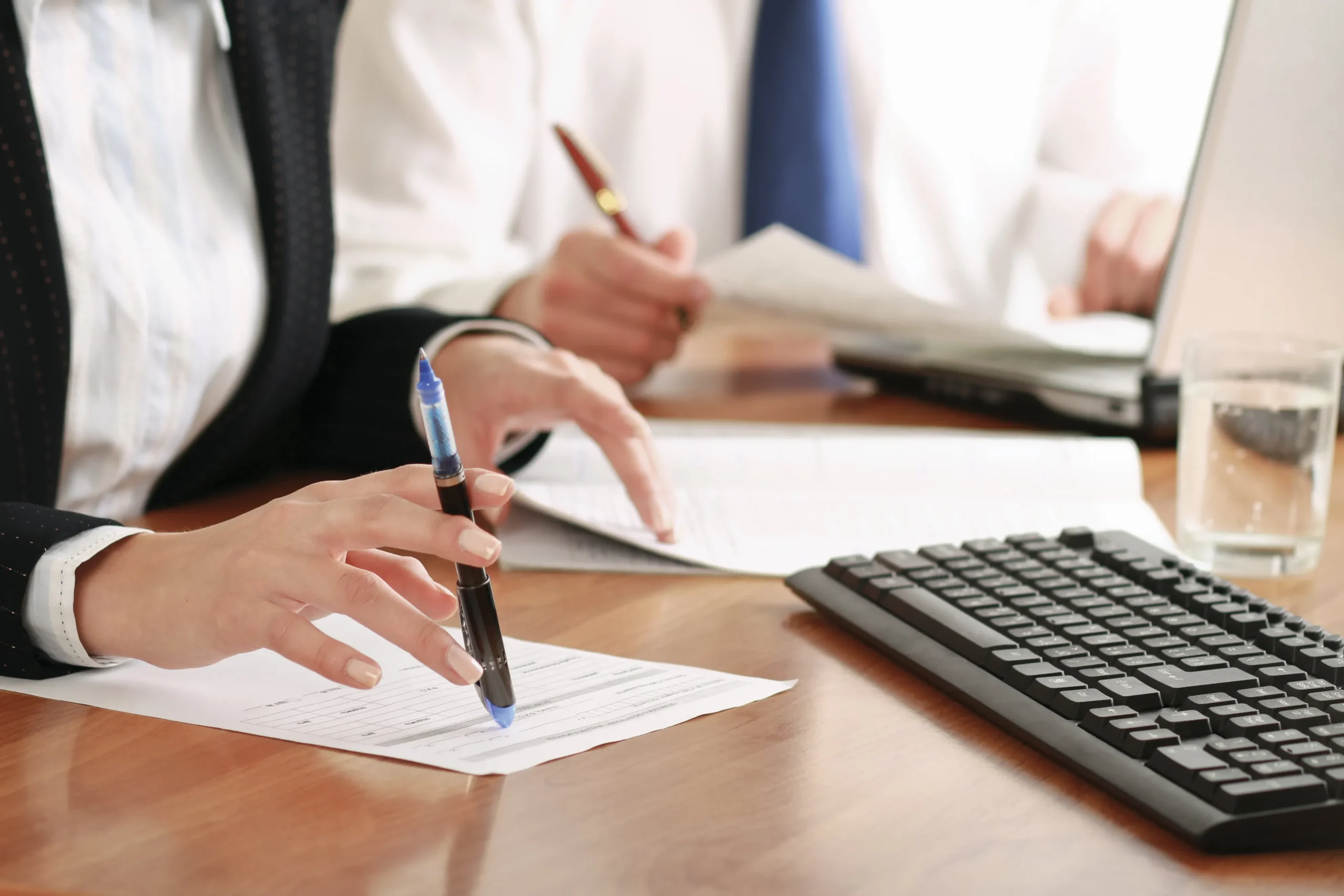 A group of attorneys working at a desk.