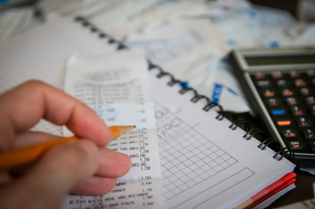 Someone reviewing receipts while filing taxes.