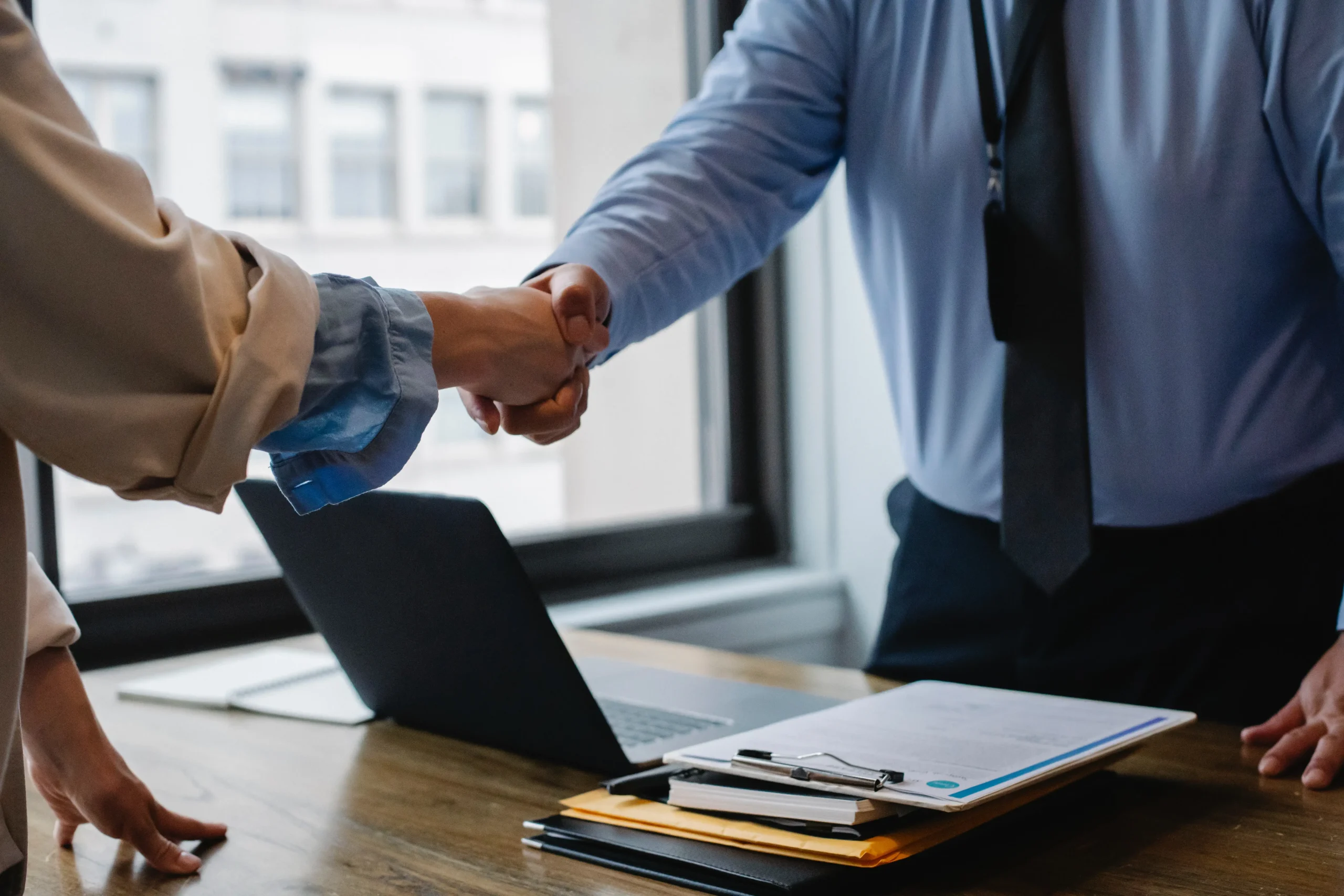 A woman shaking hands with a tax attorney.