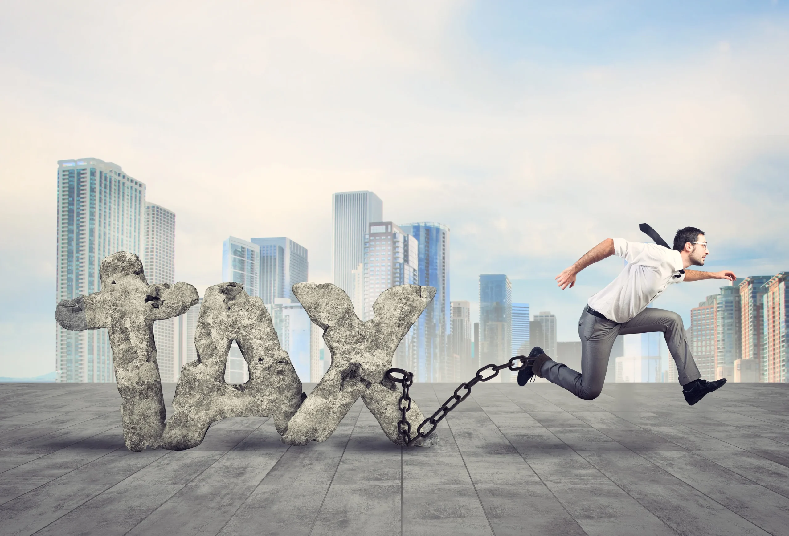 A man running with TAX chained to his leg.