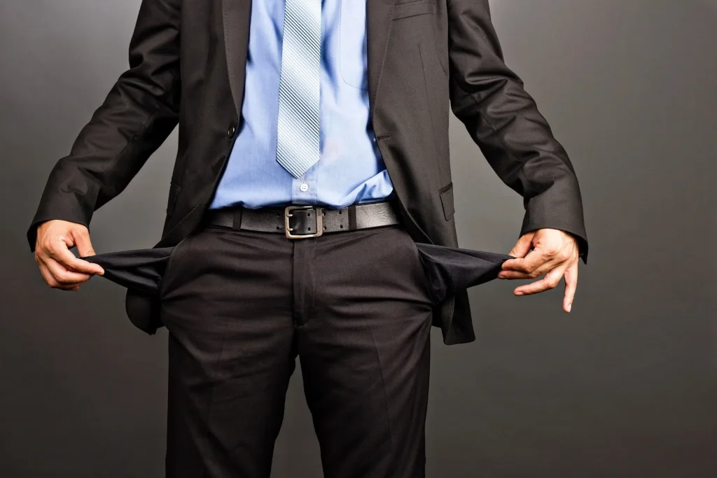 A business man pulling out his empty pockets.