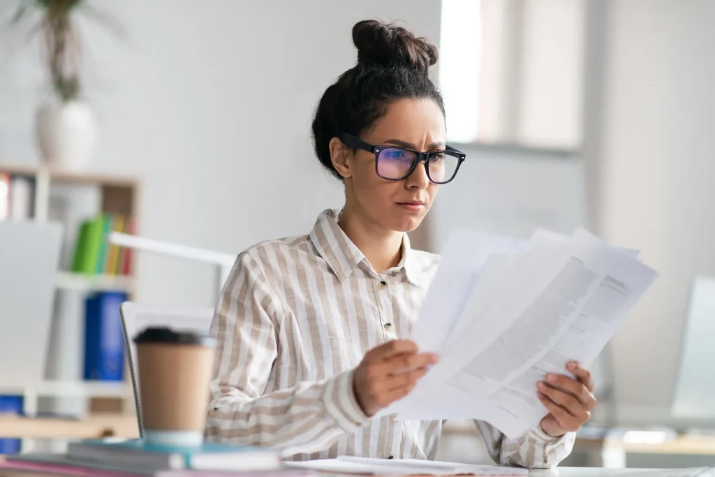 A business woman looking over a tax audit notice.